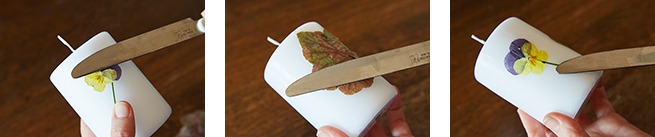 温めたナイフでキャンドルに押し花を押さえつけるように貼りつけていく。花びら、茎、葉…というように、パーツごとに貼り付けていくと失敗が少ない。